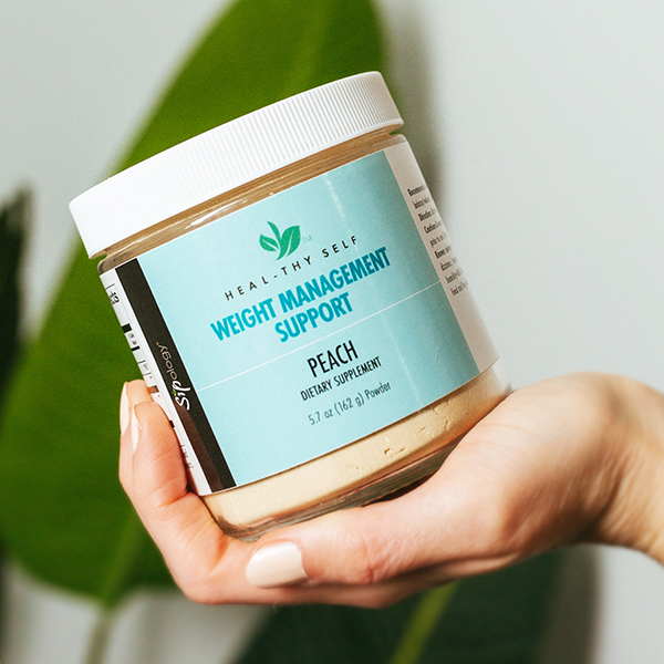 Hand holding jar of Weight Management Support boost